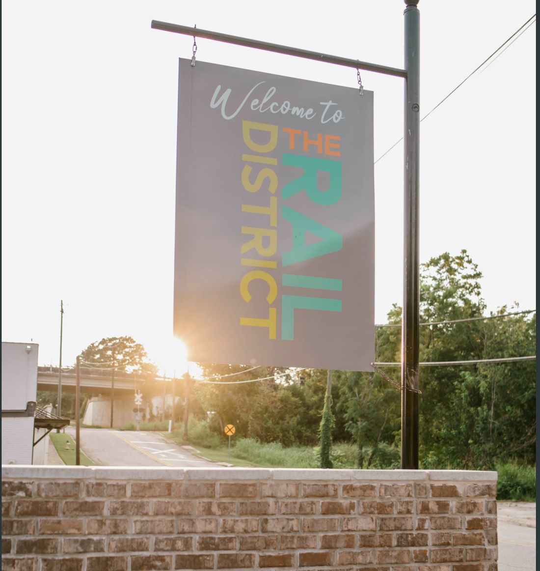 "Welcome to the Rail District" banner sign.